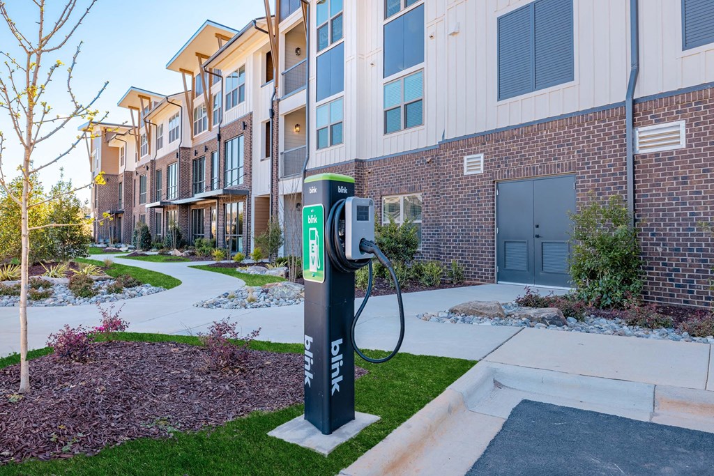 an electric charger in front of an apartment building