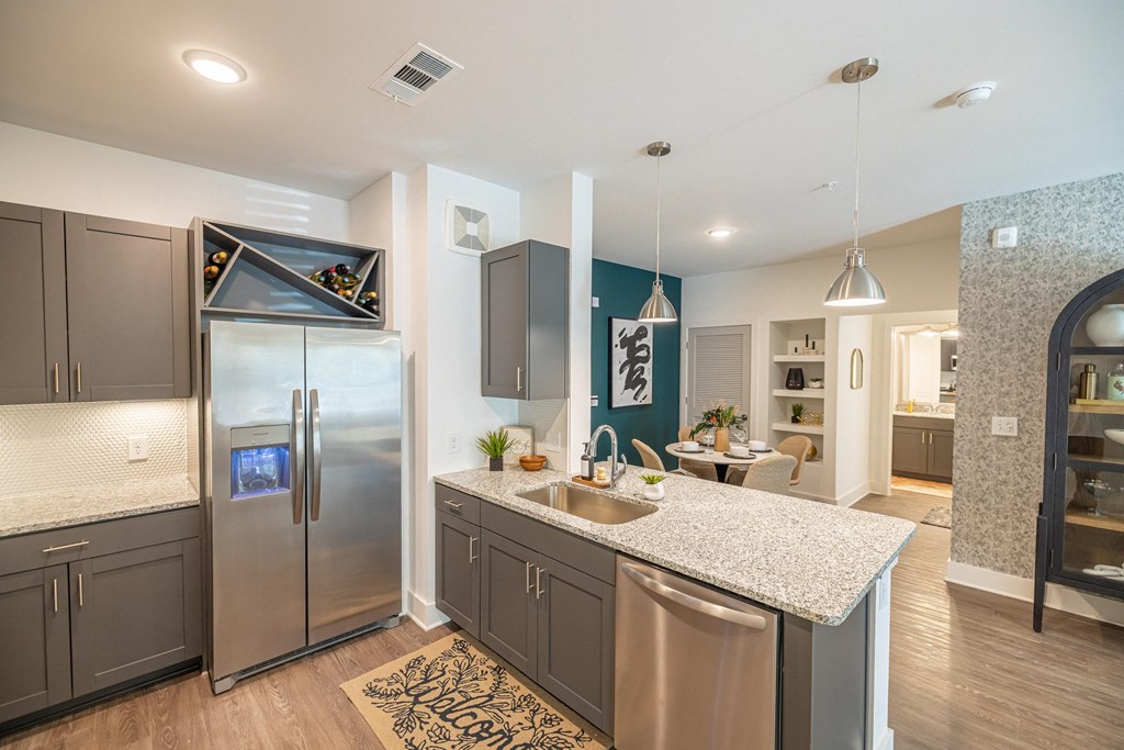 a kitchen with stainless steel appliances and granite counter tops
