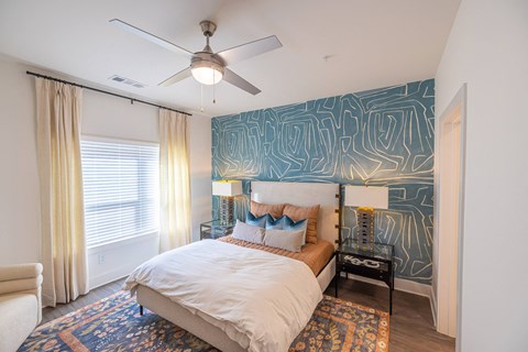 a bedroom with a bed and a ceiling fan