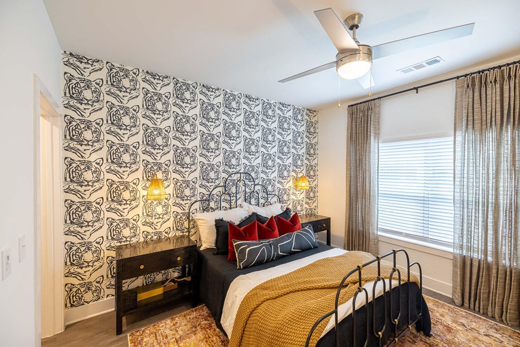 a bedroom with a bed and a ceiling fan