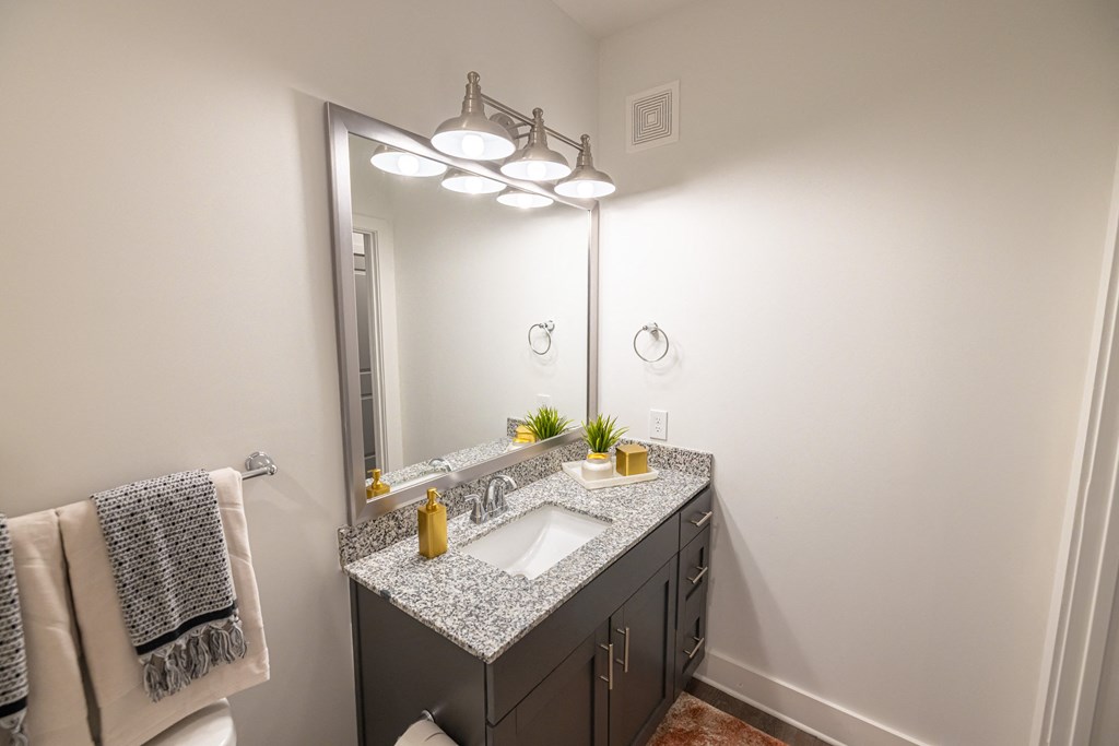 a bathroom with a mirror and a sink and a mirror