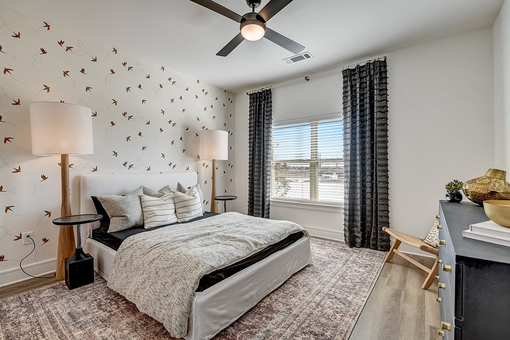 a bedroom with a bed and a ceiling fan