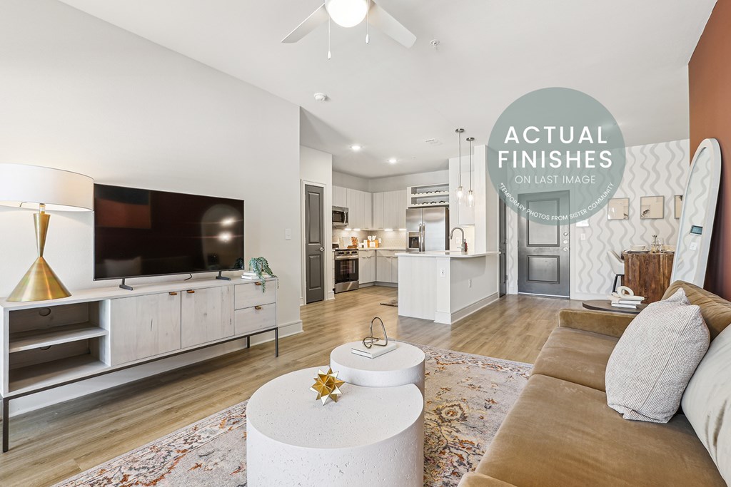 A living room with a television, a couch, and a coffee table.