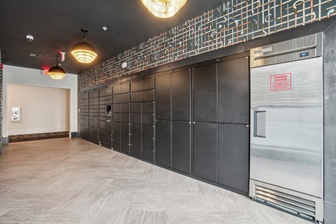 A kitchen area with a wall of tiled backsplash and a stainless steel refrigerator.