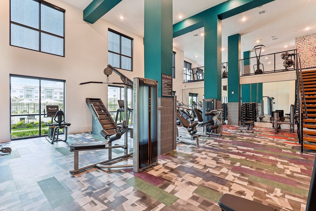 a gym with weights and cardio equipment at the estates apartments