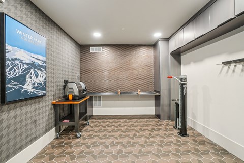 A bathroom with a poster on the wall and a sink in the middle.