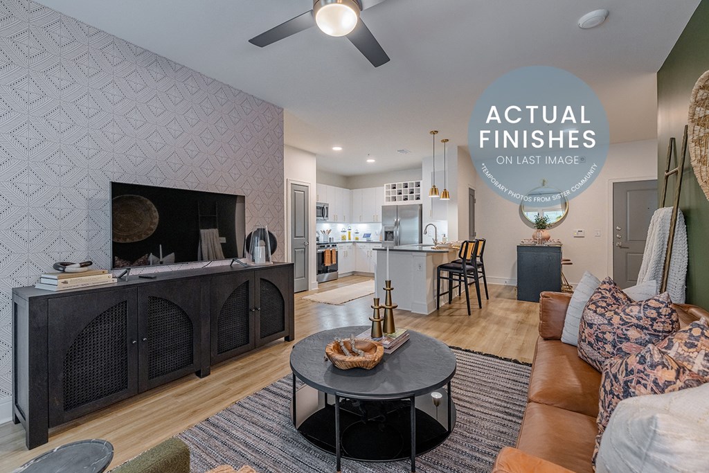 a living room and kitchen with a couch and a coffee table