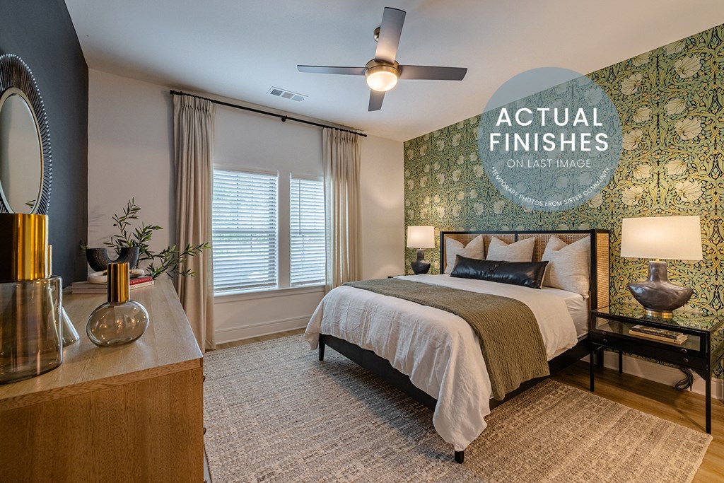 a bedroom with a green wallpaper and a bed