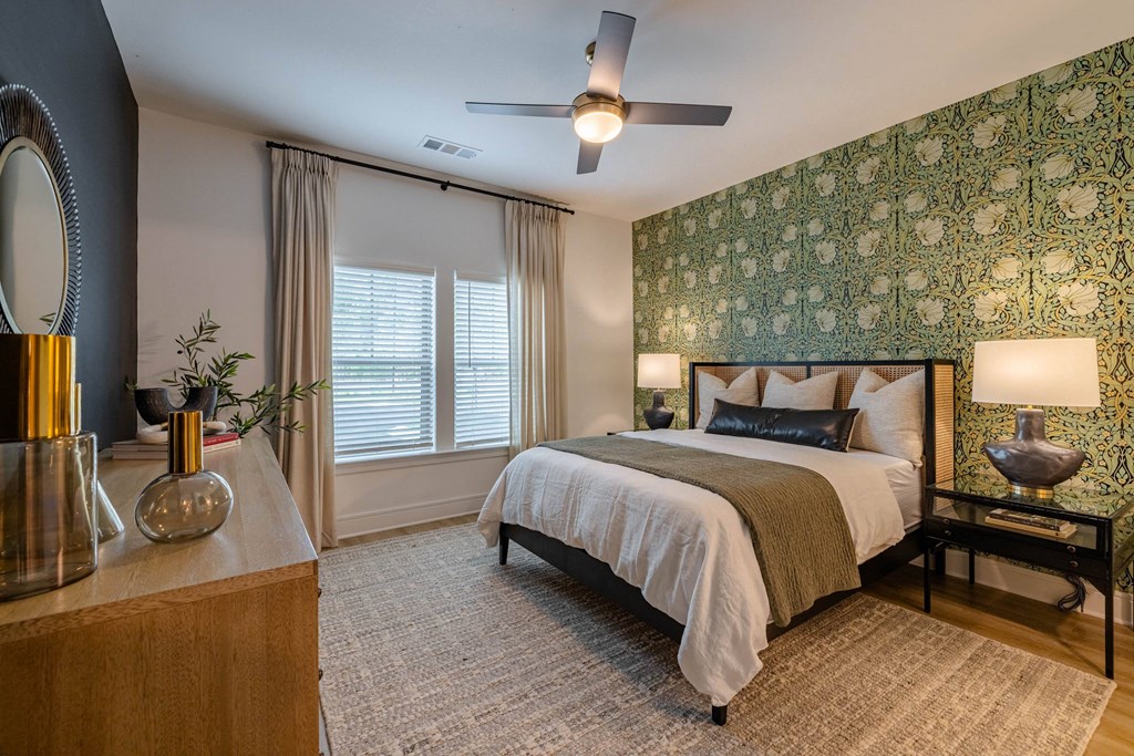 a bedroom with a bed and a ceiling fan