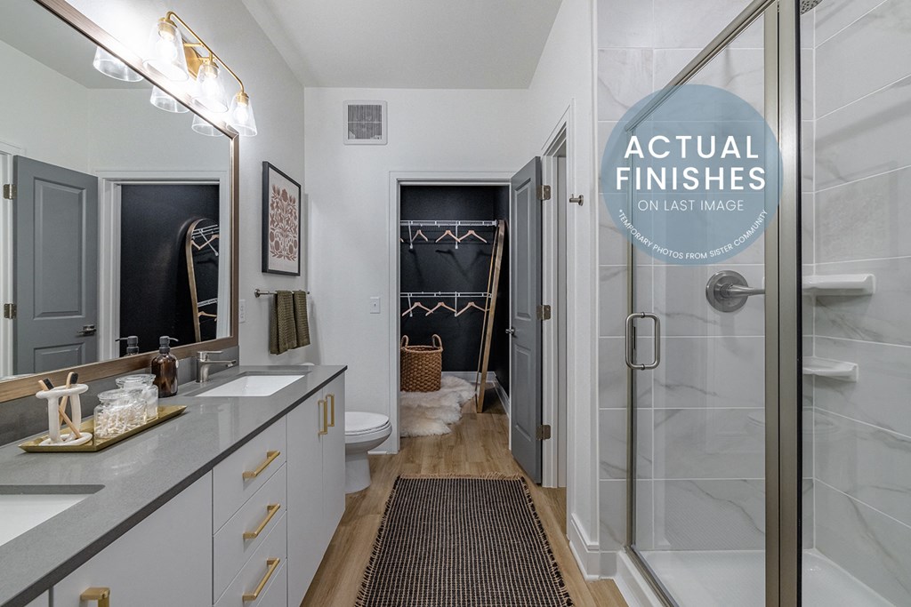 a bathroom with a shower and a sink and a rug