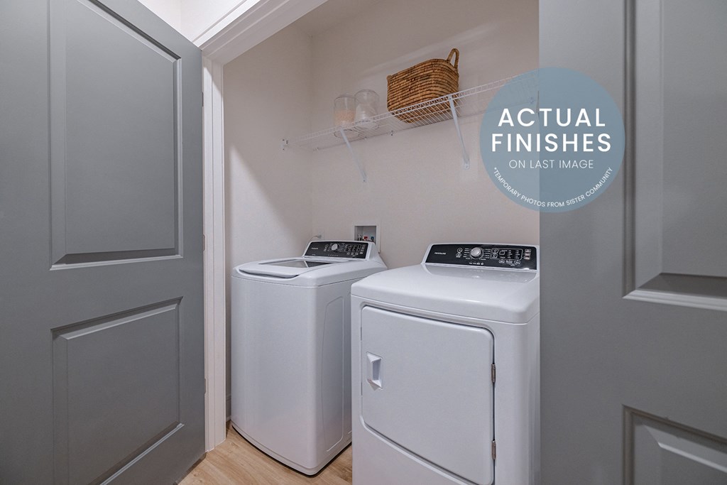 a white washer and dryer in a laundry room with a white door