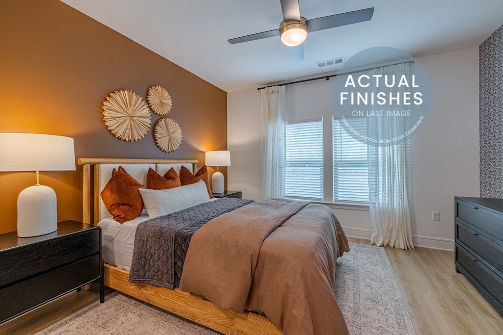 a bedroom with a large bed and a ceiling fan