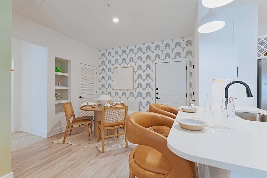 a living room and dining room with a table and chairs