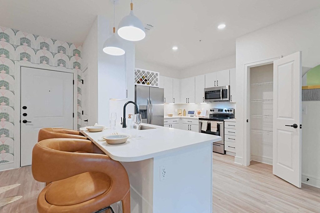 a kitchen with a white counter top and an island