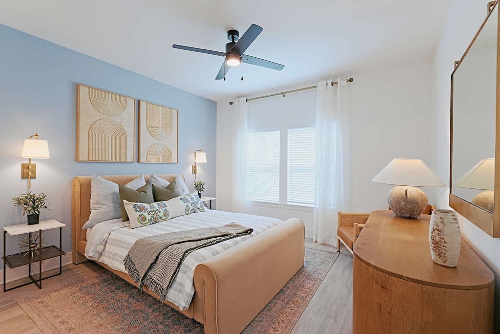 a bedroom with a bed and a ceiling fan