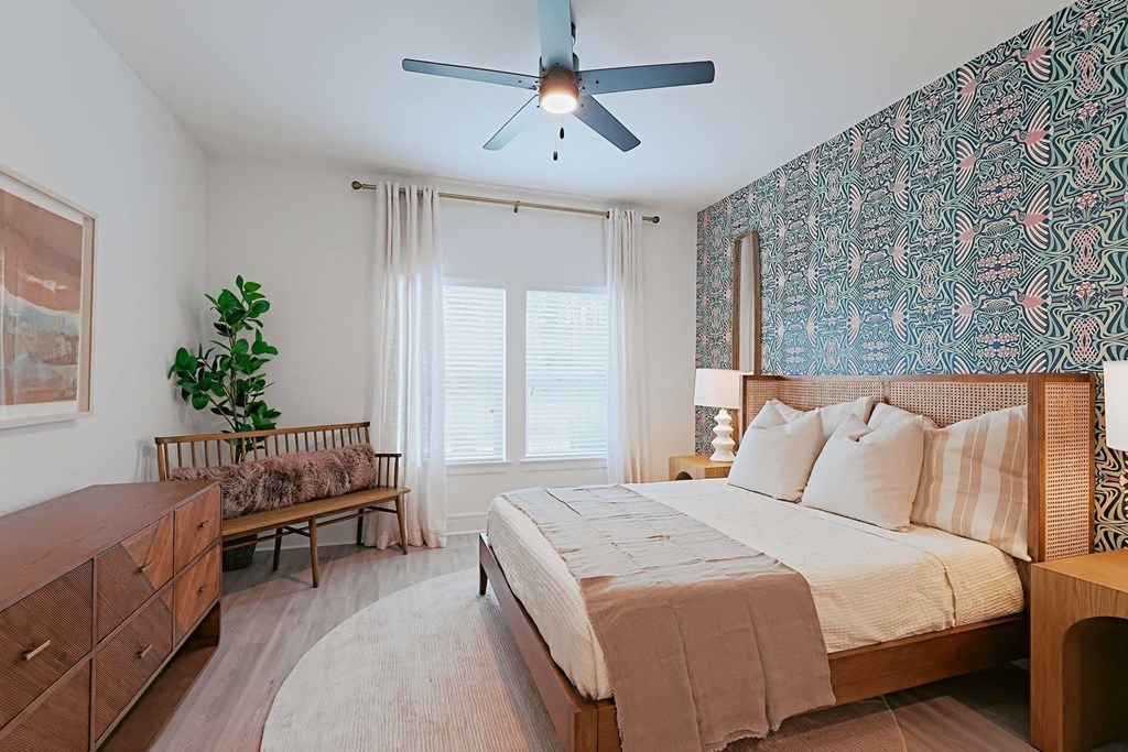 a bedroom with a bed and a ceiling fan