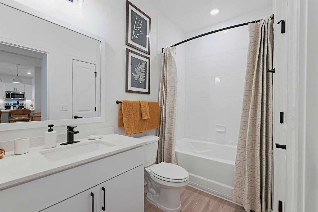 a bathroom with a shower and a sink and a toilet