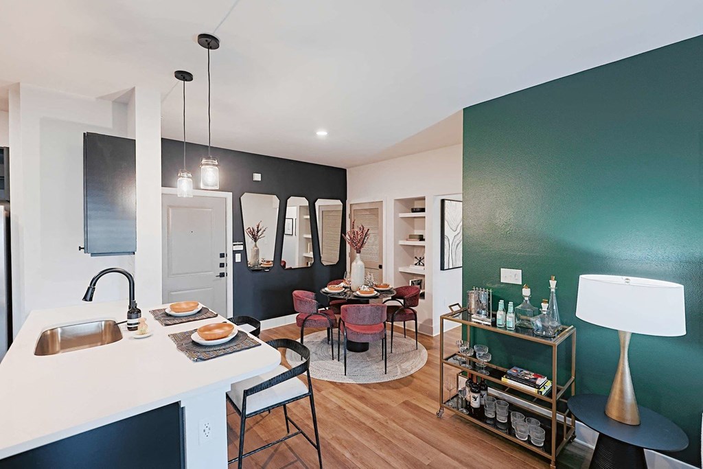 a living room and dining room with a table and chairs