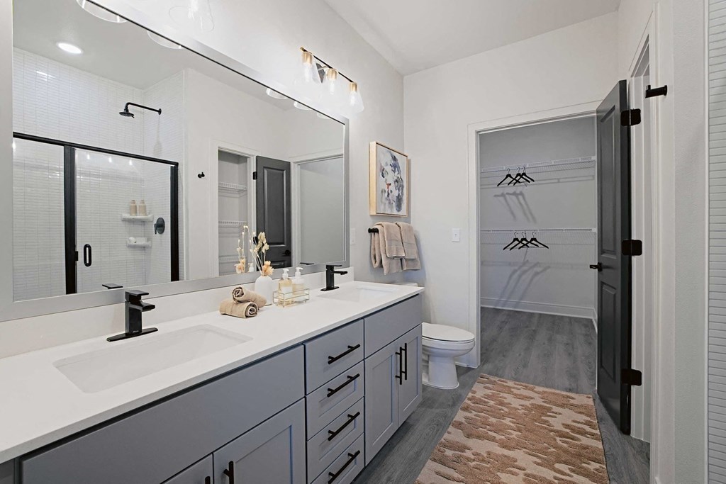 a bathroom with a sink and a shower and a toilet