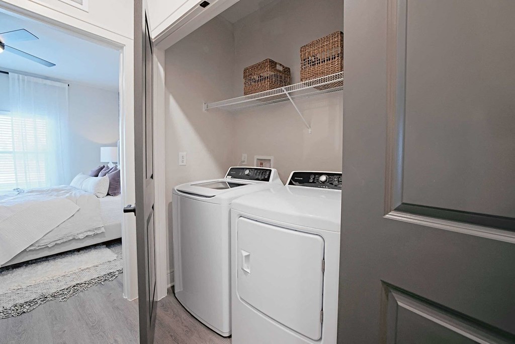 a washer and dryer in a laundry room next to a bedroom
