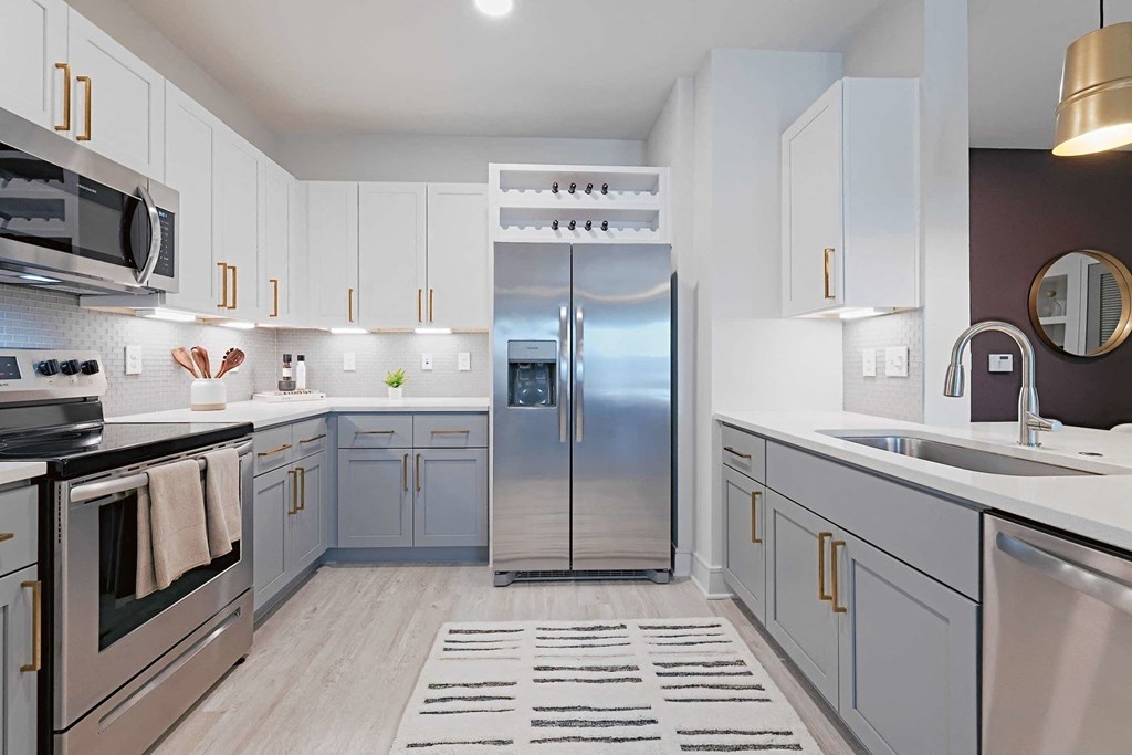 a kitchen with stainless steel appliances and white cabinets