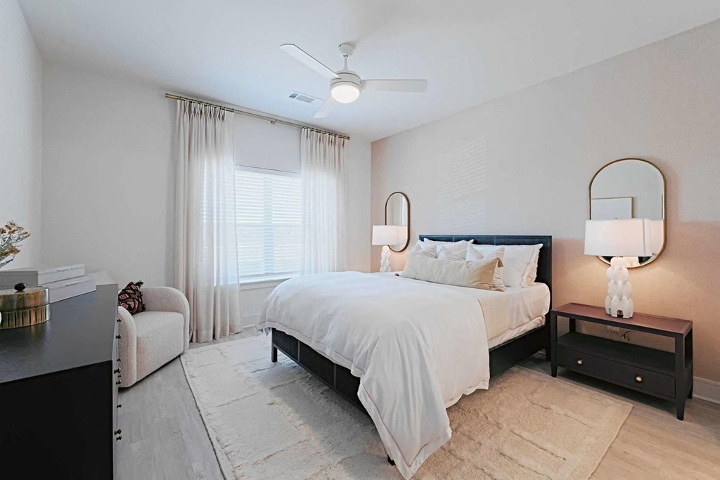 a white bedroom with a bed and a window