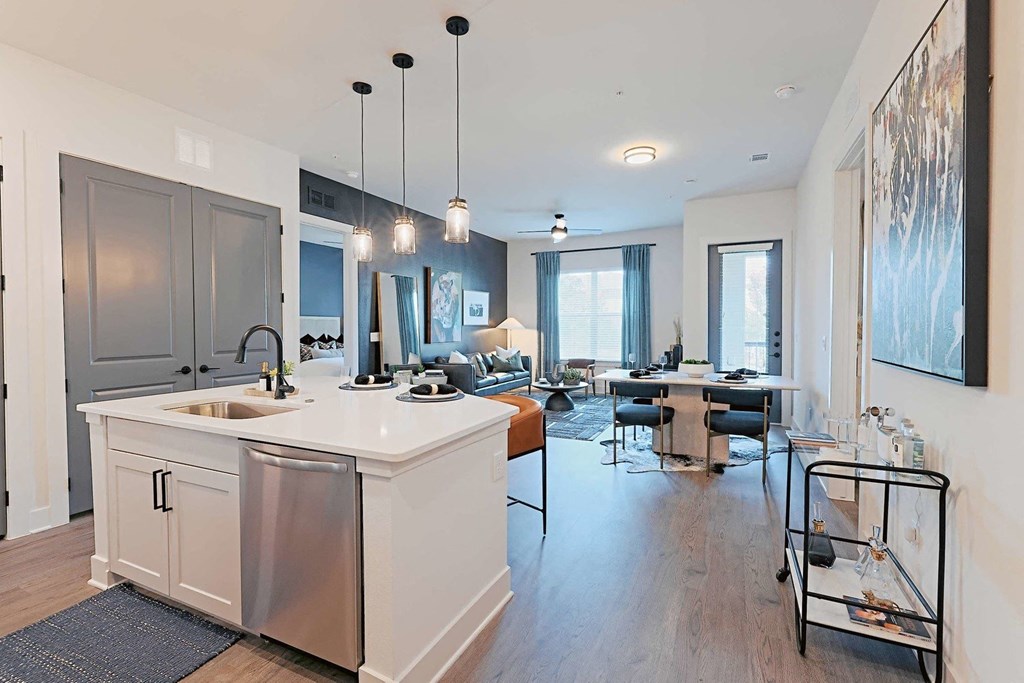 a kitchen with an island and a living room with a dining room