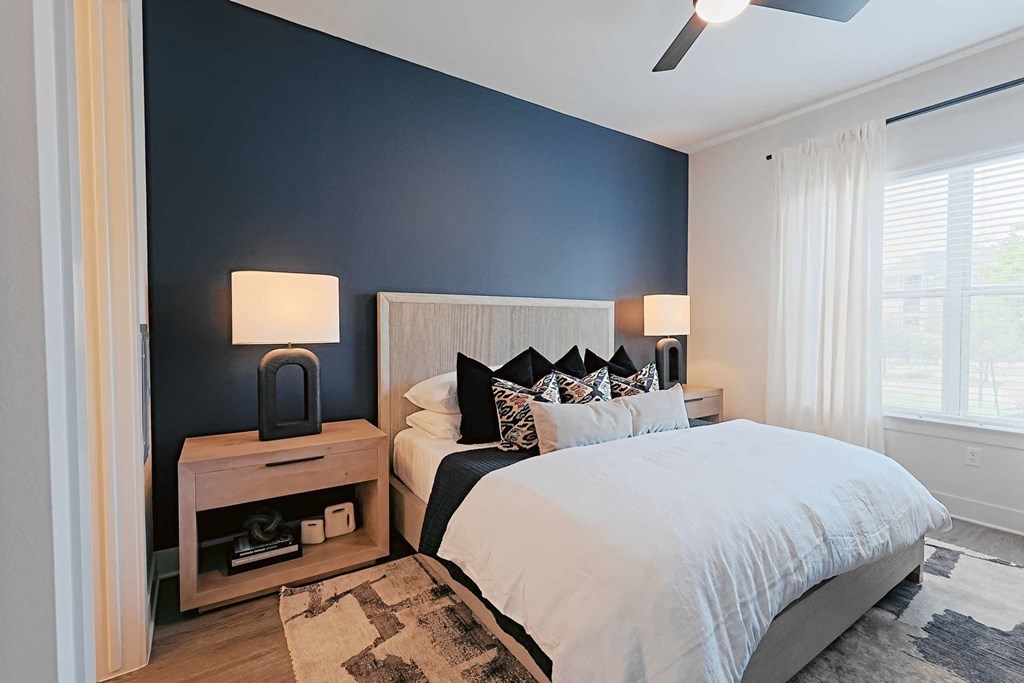 a bedroom with a bed and a blue wall