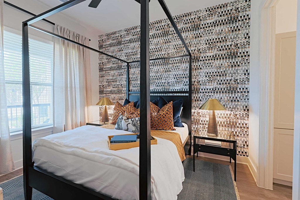 a bedroom with a bed in front of a wall covered in