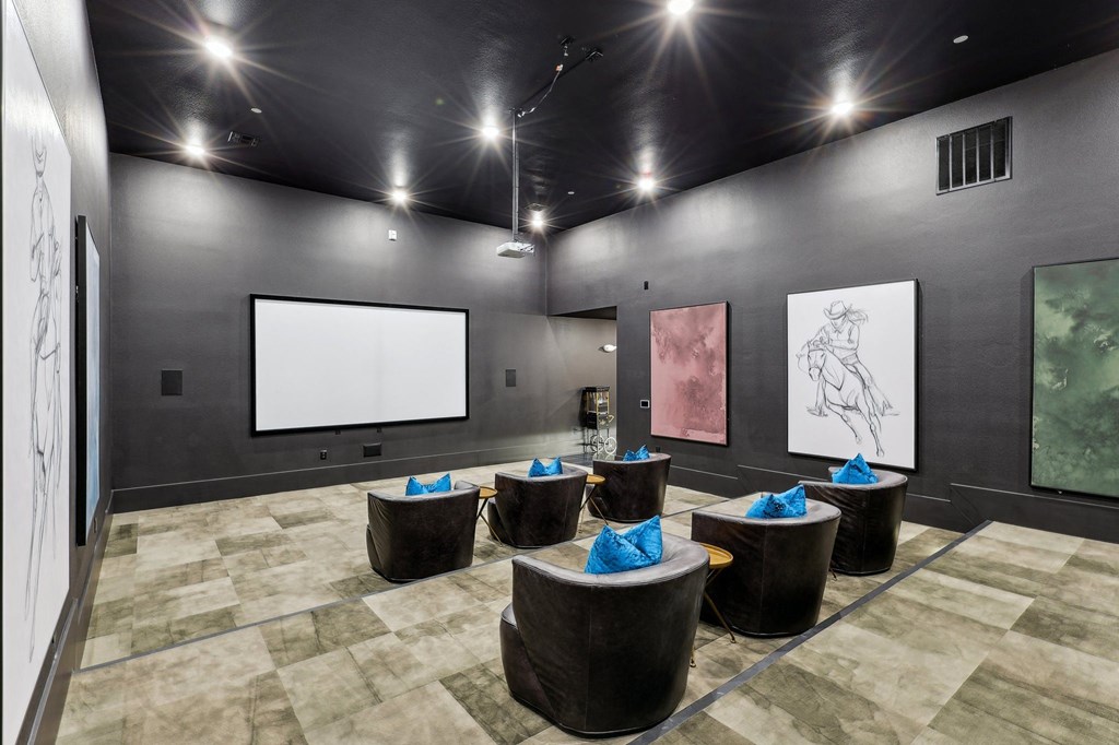 a large room with a projector screen in the center of it