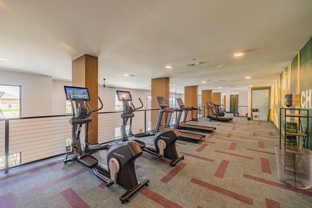 a workout room with cardio equipment in a hotel gym