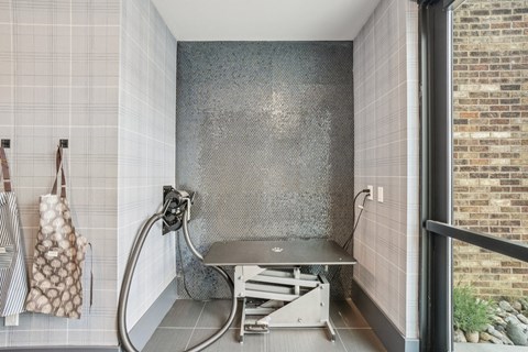 A bathroom with a shower and a bench.