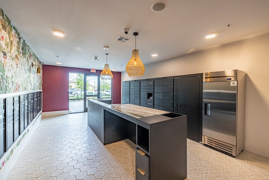 the kitchen has a large island and stainless steel appliances