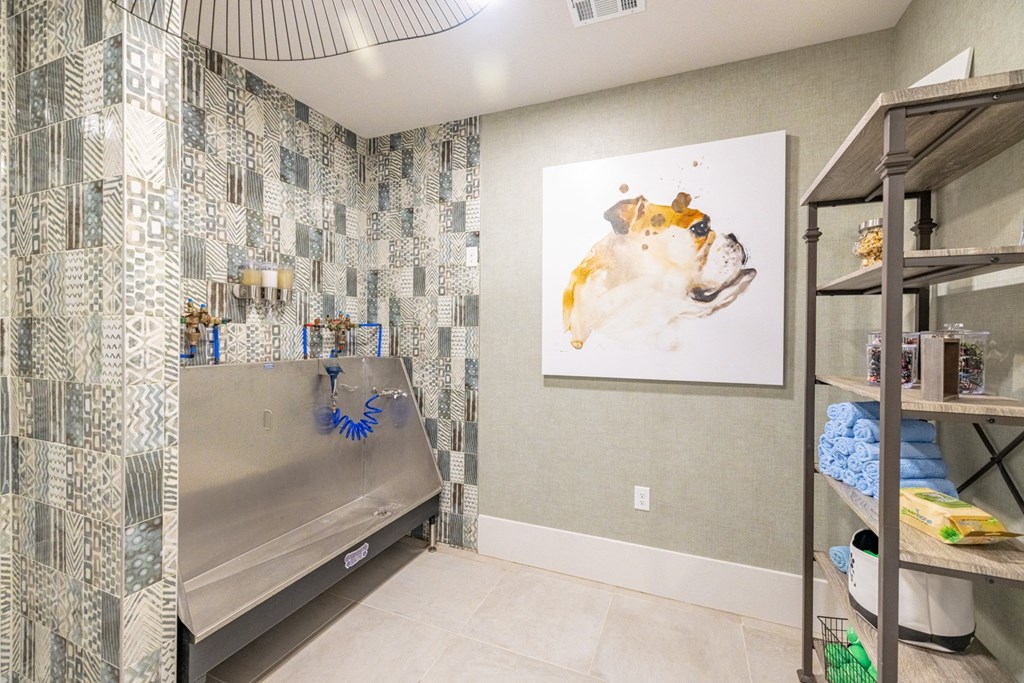 a bathroom with a shower and a sink and a painting on the wall