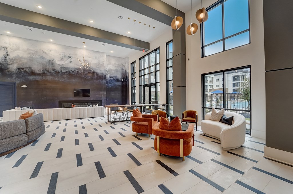 a large lobby with couches and chairs and a fireplace