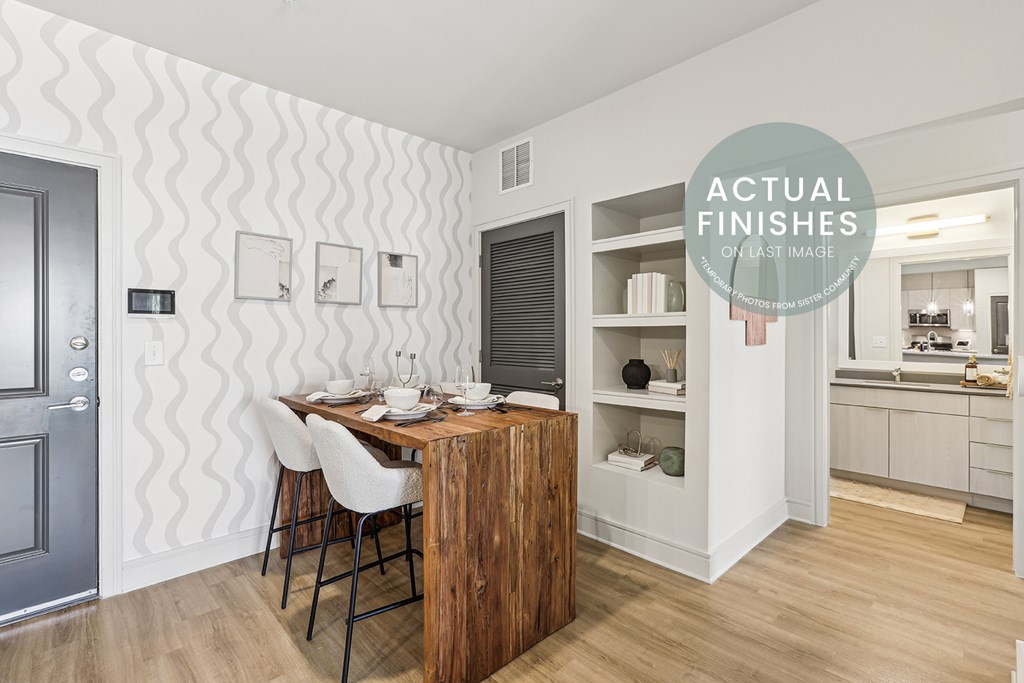 A dining area with a wooden table and chairs.