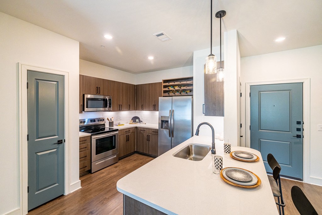 a kitchen with stainless steel appliances and a white counter top