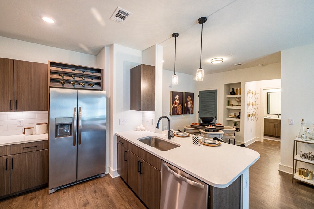 a kitchen with stainless steel appliances and a white counter top