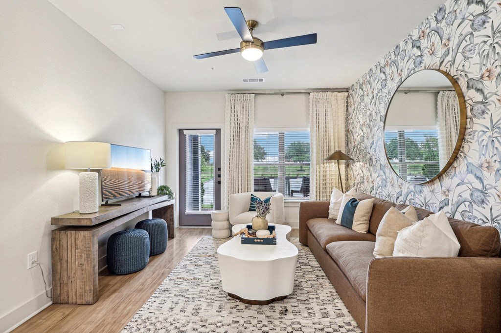 a living room with a brown couch and a white coffee table