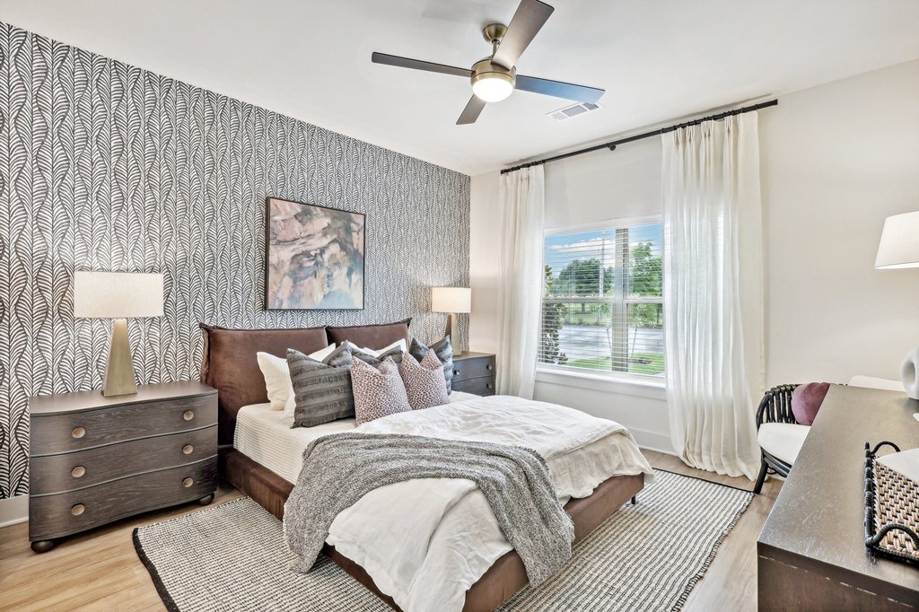 a bedroom with a bed and a ceiling fan