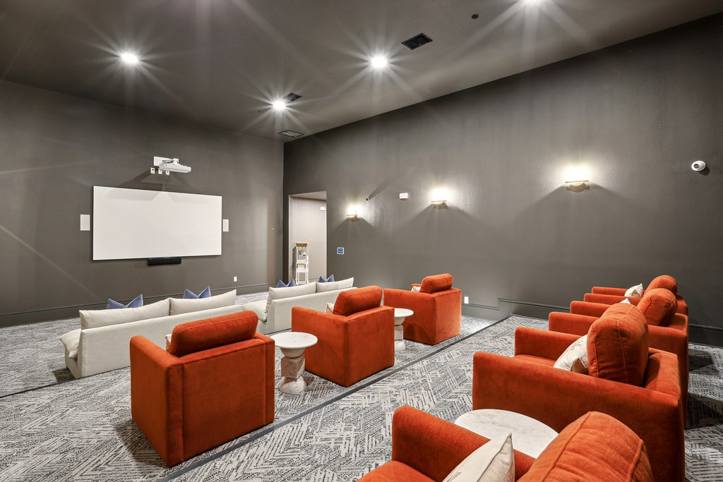 A room with a grey wall and a white screen on the wall.