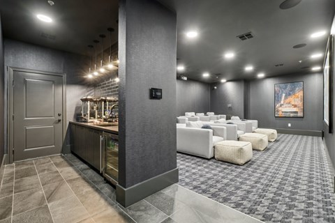 A modern kitchen with a bar area and a dining area with white furniture.