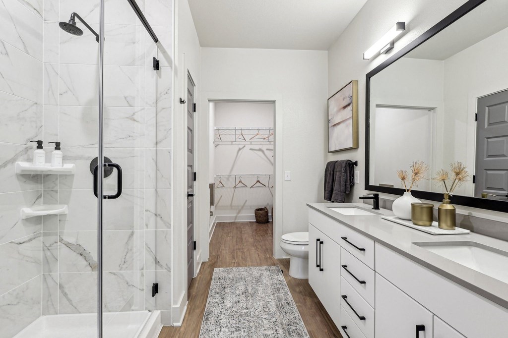 a bathroom with a shower and a sink and a mirror