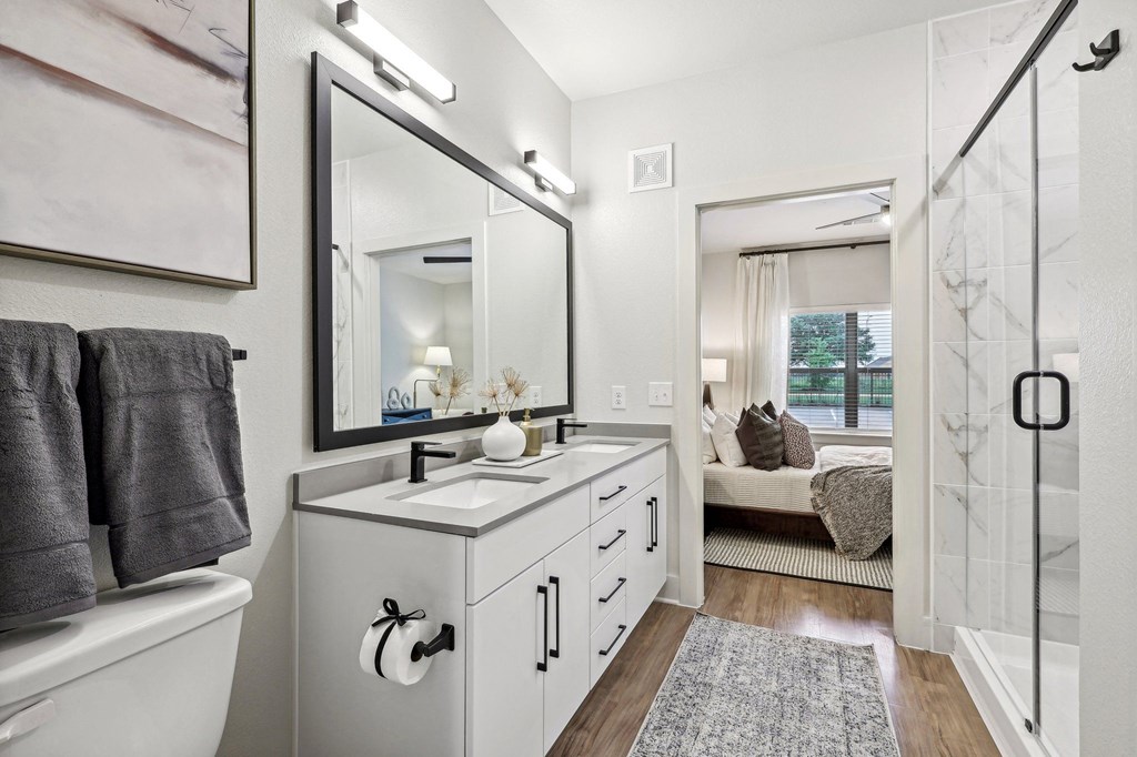 a bathroom with a large mirror and a sink and a shower