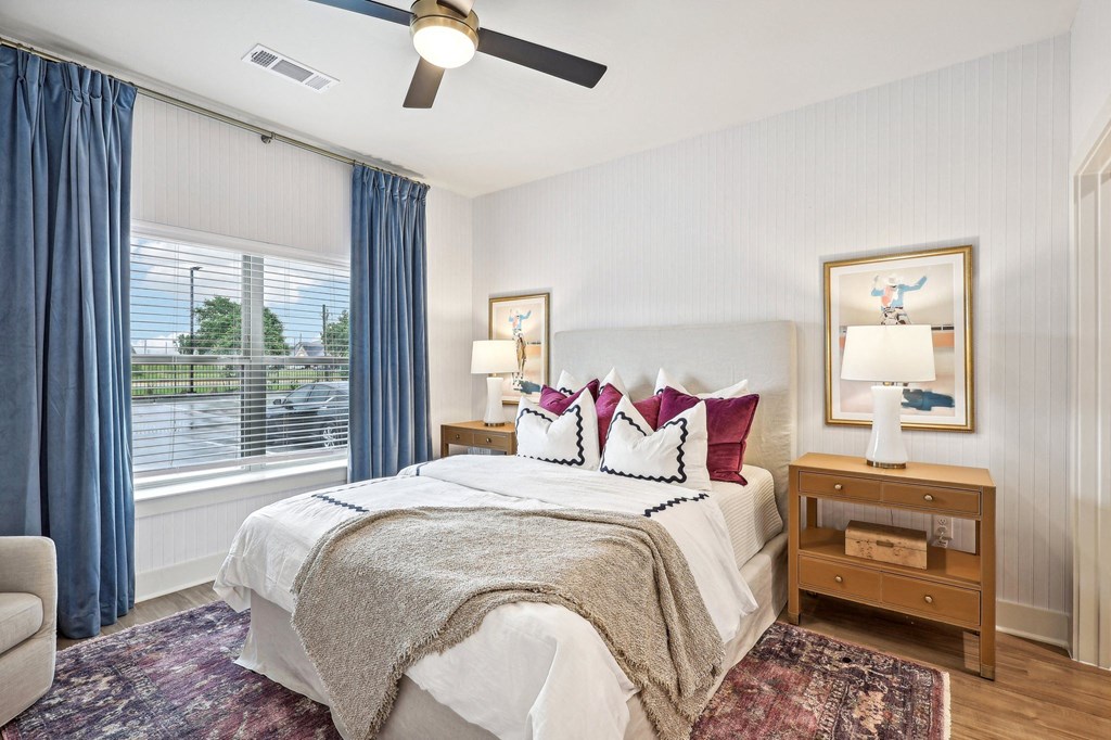 a bedroom with a large bed and a ceiling fan