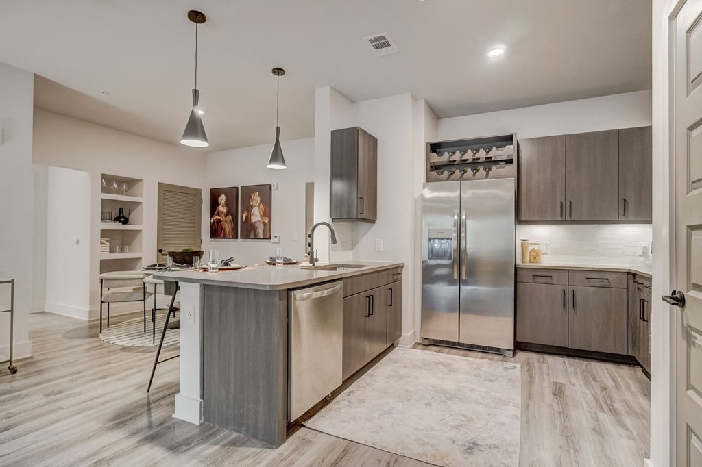 a kitchen with stainless steel appliances and a marble counter top