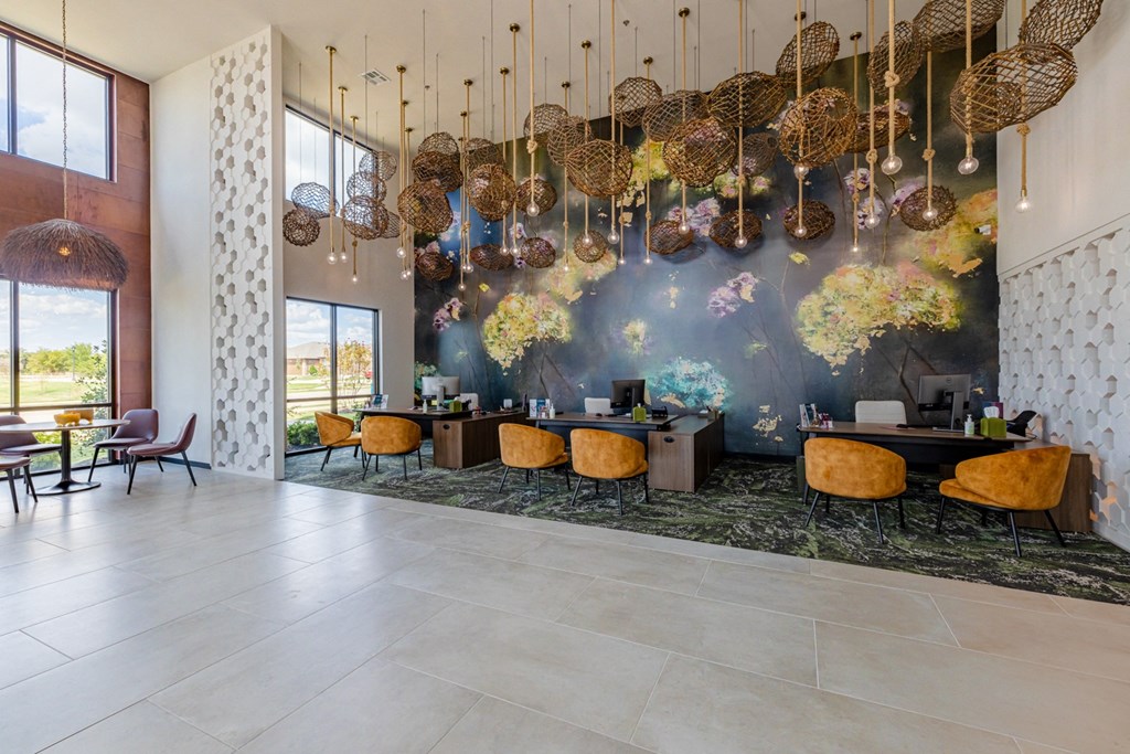 the lobby of a hotel with chairs and a large wall with chandeliers