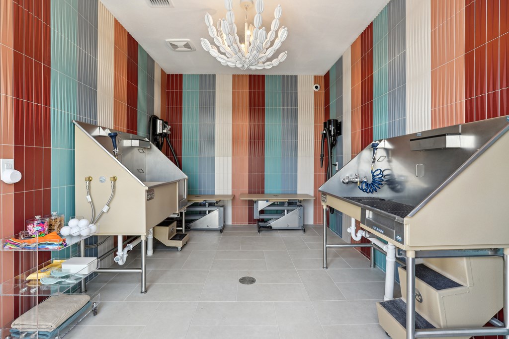 A kitchen with two ovens and a chandelier hanging from the ceiling.