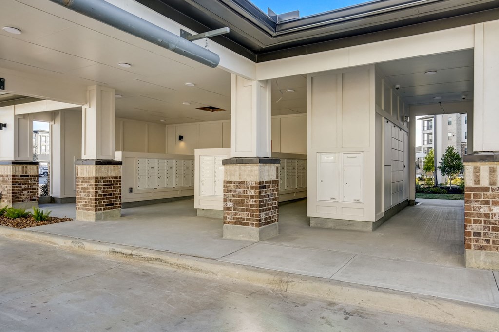 the lobby of an apartment building with columns and mailboxes