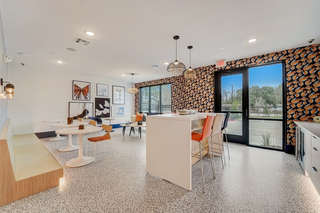 a kitchen and dining area with tables and chairs and a large window